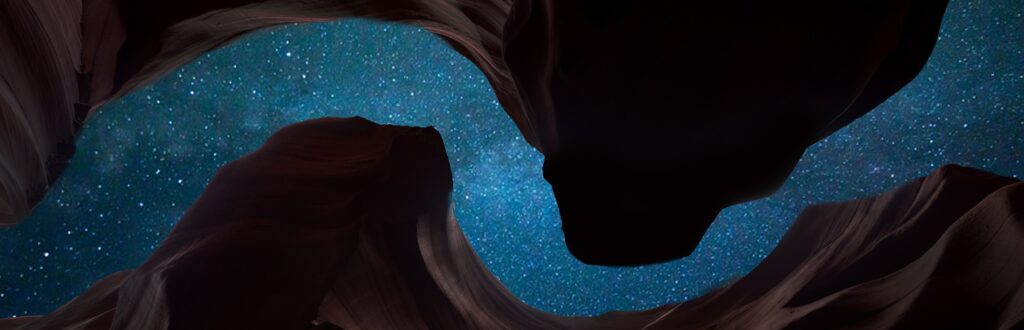 View of the starry sky from a deep, winding gorge