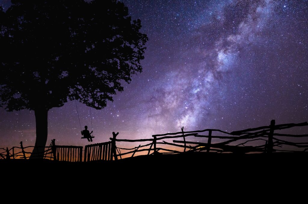 Milky Way, in front of person on swing